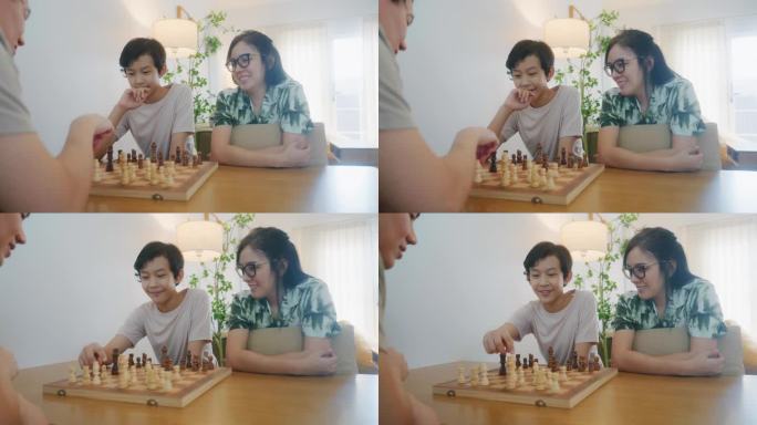 家庭时光，父子俩边下棋边有说有笑。