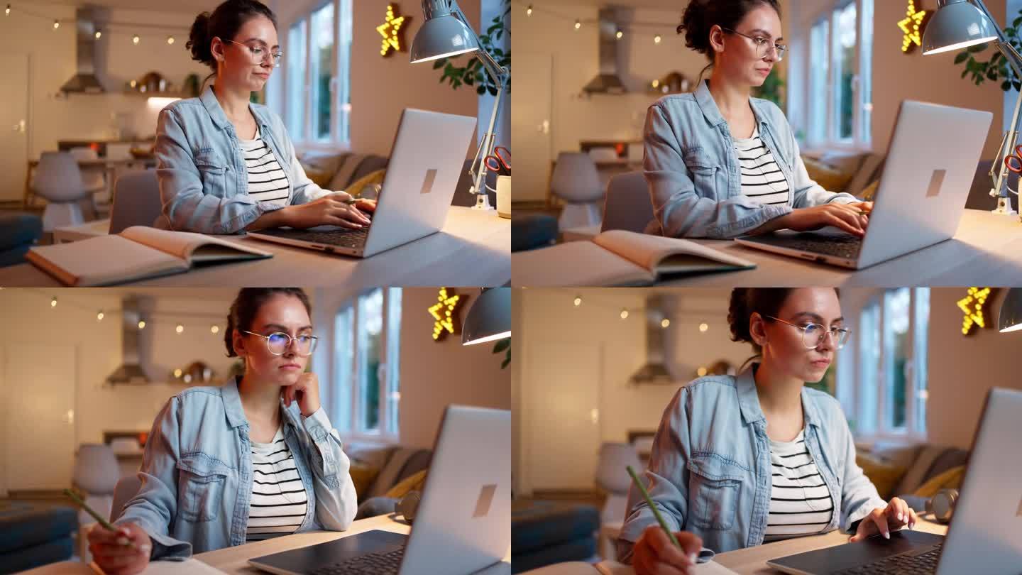 专注的年轻女性在家里学习，同时使用笔记本电脑