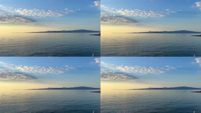 背景广告旅行到大海或海洋只有天空和水的地平线浅蓝色的海洋和黄色的日落自然山脉可见在远处空框为文字