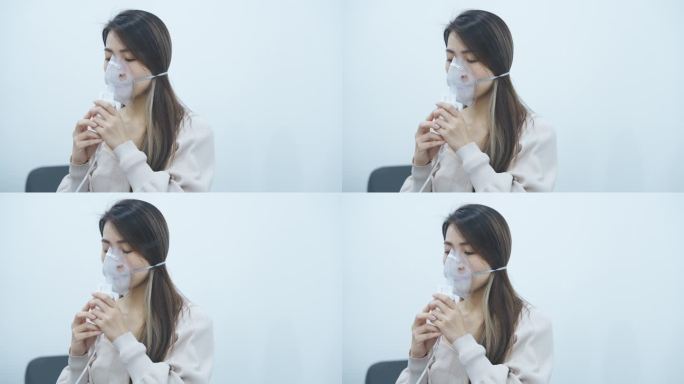 患有哮喘的亚洲华裔中年妇女正在吸氧