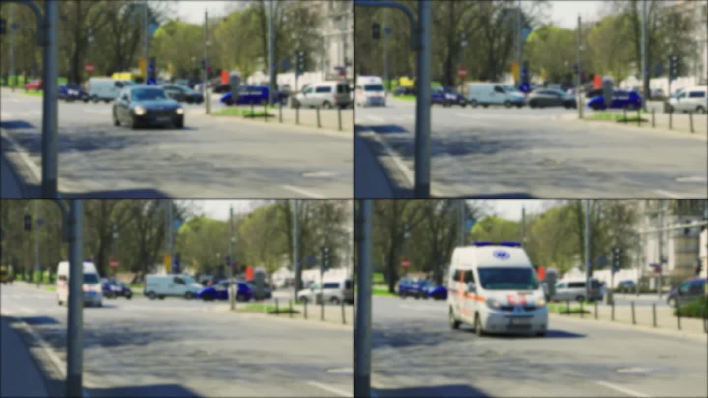 一辆救护车开在繁忙的城市街道上，蓝色的信标闪烁着