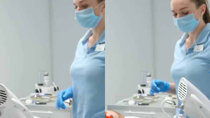 牙科诊所尖端技术病人医生和护士做牙齿美白当它结束医生拿起机器特殊技术防紫外线护目镜蓝色衣服白色背景