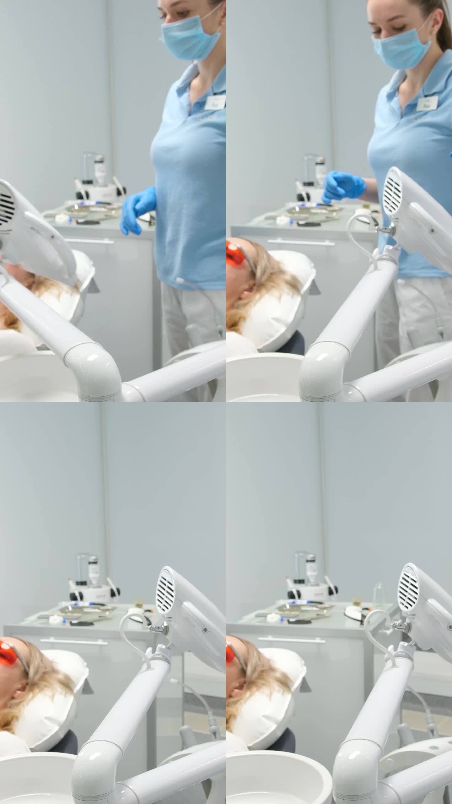 牙科诊所尖端技术病人医生和护士做牙齿美白当它结束医生拿起机器特殊技术防紫外线护目镜蓝色衣服白色背景