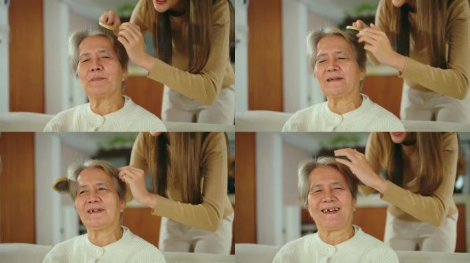 亚洲妇女在家中客厅为老年妇女梳头。