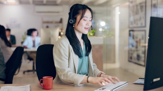 呼叫中心，电脑或快乐的亚洲女人解释帮助台服务，软件系统或客户关系管理沟通。联合办公中的技术支持对话、