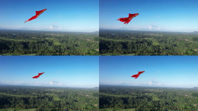 红色的大风筝在绿色的风景上翱翔，航拍镜头近距离拍摄