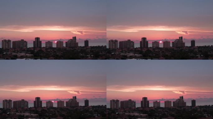 橙色的夕阳和佛罗里达那不勒斯海岸高层建筑的剪影。航拍变焦照片