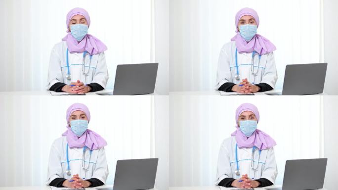 戴口罩的穆斯林医生坐在私人诊所办公室里
