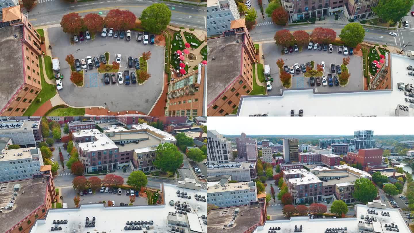 鸟瞰许多五颜六色的汽车停在公寓楼后院的停车场上。住宅公寓前的车辆停放处