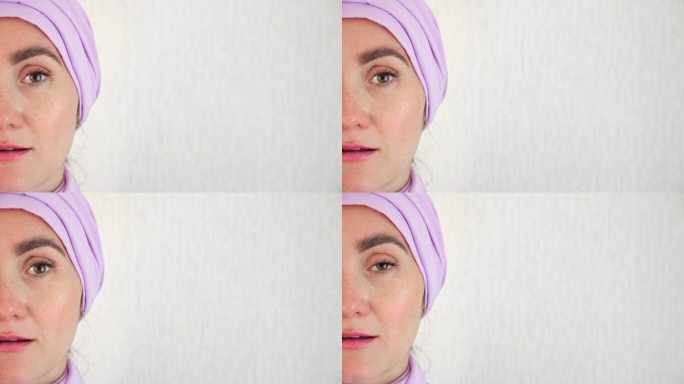 一名穆斯林妇女站在墙边，脸上露出高兴的表情