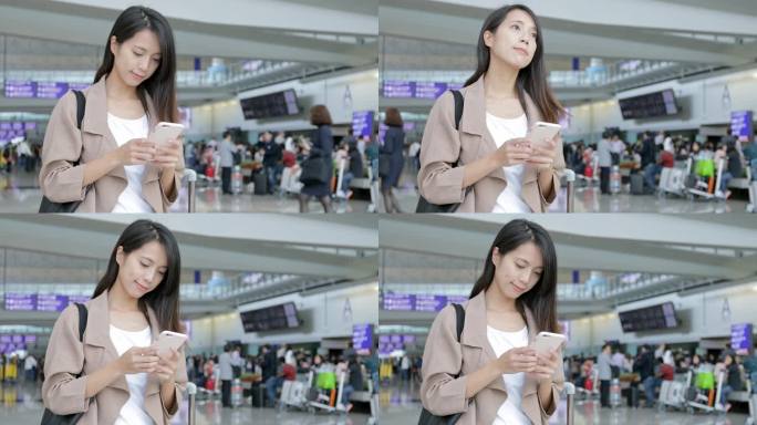 女子在香港国际机场用手机发短讯