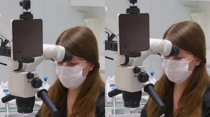 牙科诊所最新的设备和技术女医生用显微镜治疗病人的牙齿用大平板屏幕白色背景空白文字广告黄色手套黑色衣服