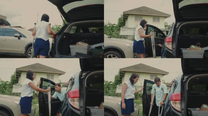 公路旅行的幸福:残疾的亚洲夫妇兴奋地收拾汽车行李箱度假时间度假