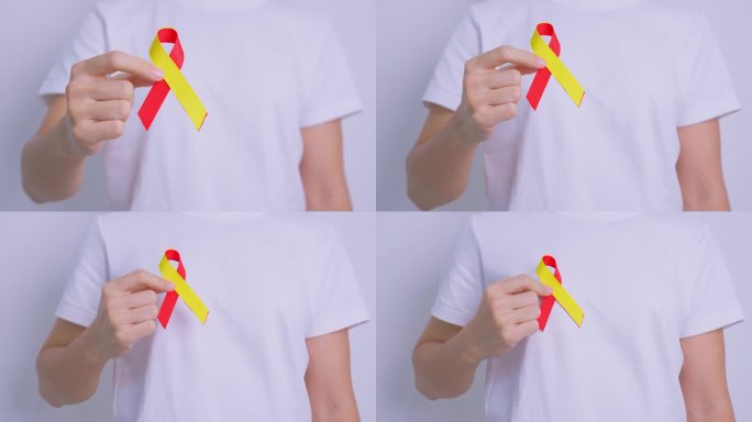 医生拿着红黄丝带。世界肝炎日宣传月，7月28日，肝癌，黄疸，肝硬化，衰竭，扩大，肝性脑病和健康概念