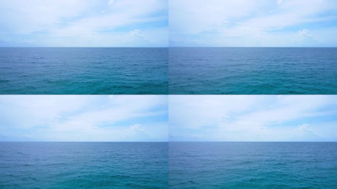 航拍海洋自然视频美丽碧蓝的大海，一望无际的地平线，蓝天，美丽的白云，笔直的平面地平线，用高质量的胶片