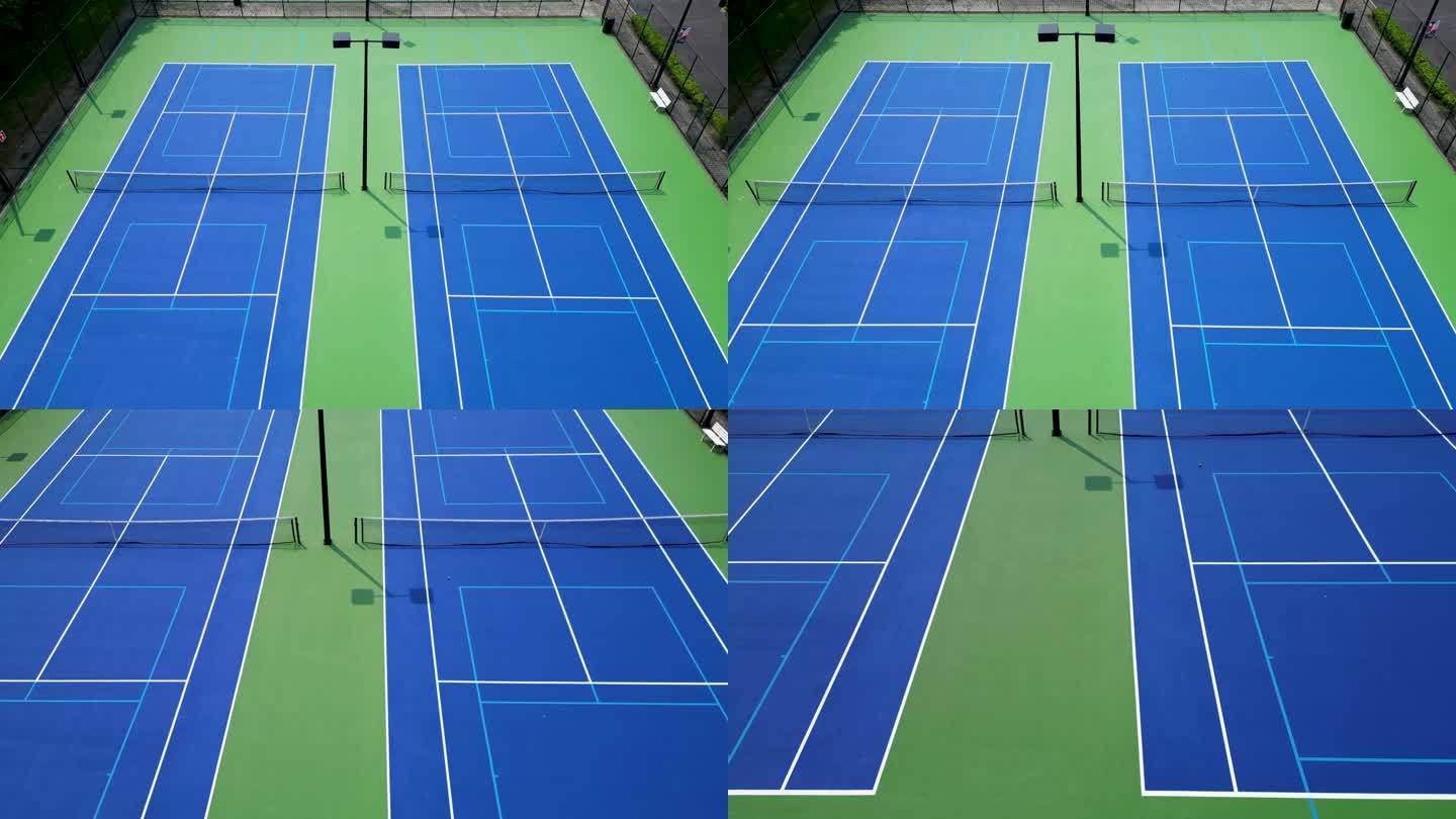 从无人机上往下看，蓝绿相间的匹克球网球场刚刚用灯光重新装修过