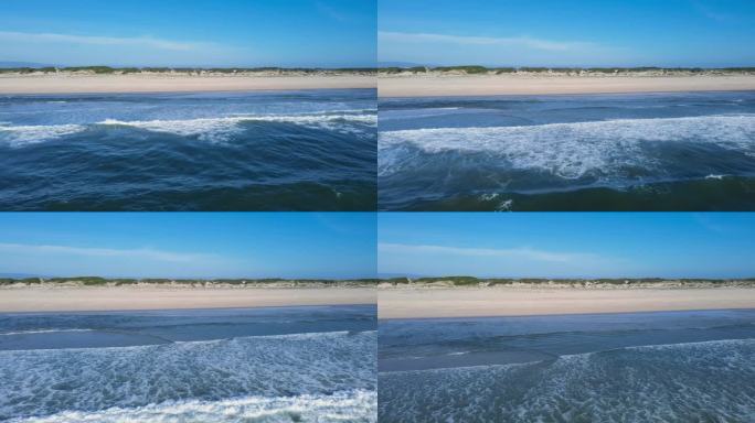 美丽的无人机视图大西洋，高浪，蓝天，和空旷的沙滩与沙丘。大西洋，蓝天，海岸线，绿沙丘。4K分辨率海滩