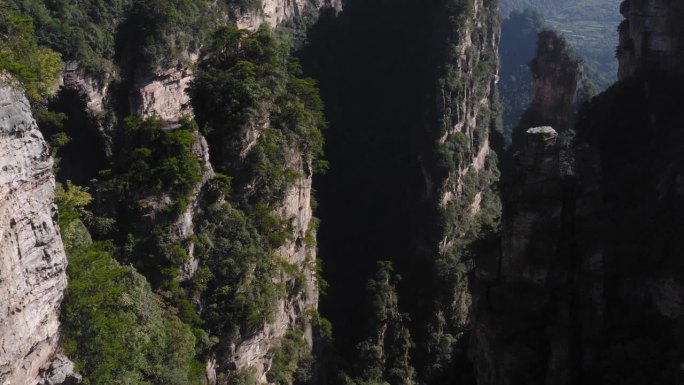 中国湖南武陵源张家界山岩尖顶和崖边植被，空中回拉倾斜向上