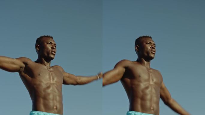 一名非洲男子开始做开合跳热身