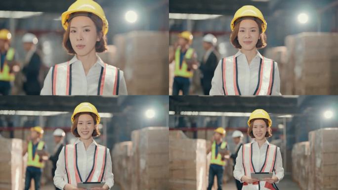 微笑的亚洲女性仓库工人在工业环境中被授权和自信