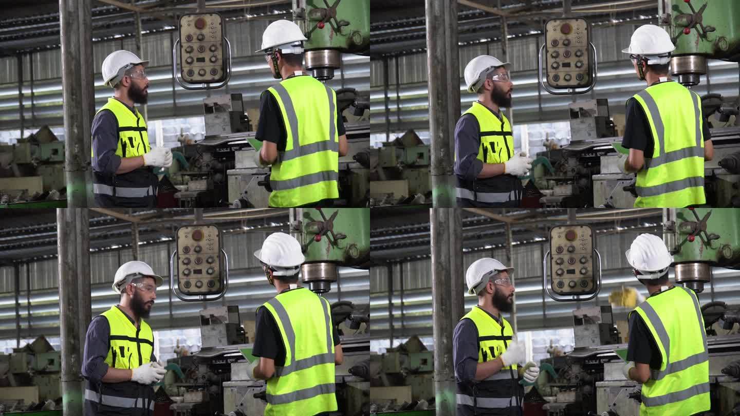 两名多元化工程师在工厂用平板电脑检查电机。阿拉伯和亚洲维修团队在制造业的维护。在工作场所检查工厂质量