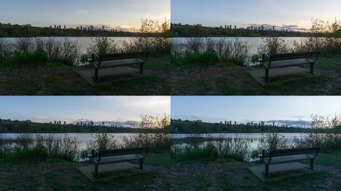 在城市公园的湖边观看的充满活力的日落的时间流逝。摄于加拿大不列颠哥伦比亚省大温哥华的本拿比