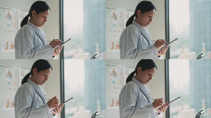 近景:在现代医院工作的手医生手持和使用数码平板电脑