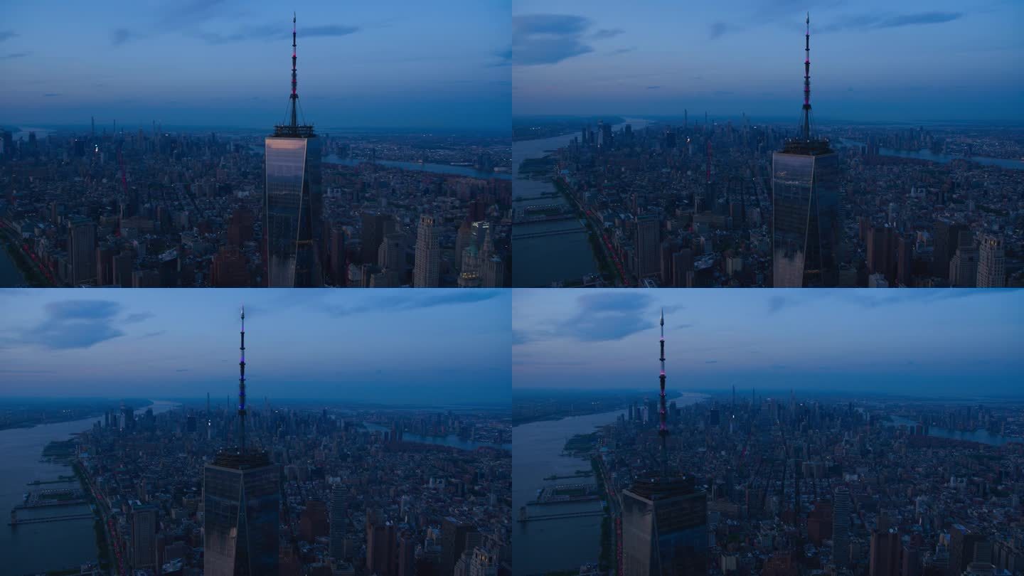 深夜航拍镜头的相机锁定在一个世界贸易中心摩天大楼顶部的天线。直升机在玻璃建筑周围飞行，俯瞰纽约市所有