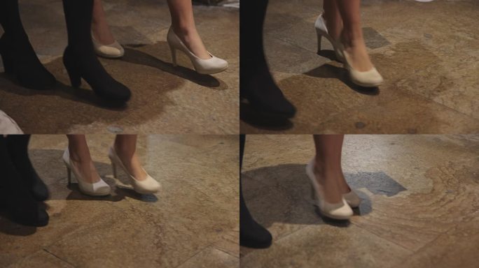 穿着高跟鞋的时尚女性走在城市街头的腿上，镜头没有显示出她们的脸