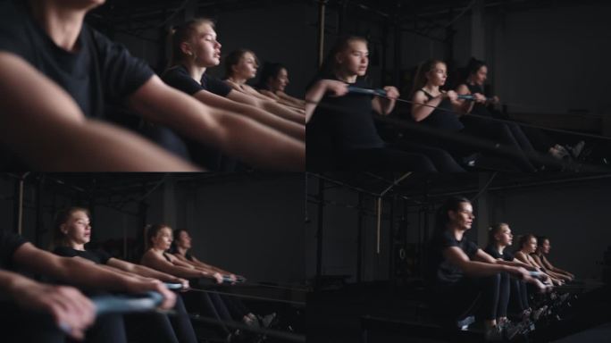 女运动员在健身俱乐部划船机上训练，在健身房进行高强度的力量训练