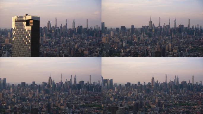 日落时分的纽约天际线。直升机航拍画面。帝国大厦与其他著名的城市地标和摩天大楼。现代混凝土丛林建筑