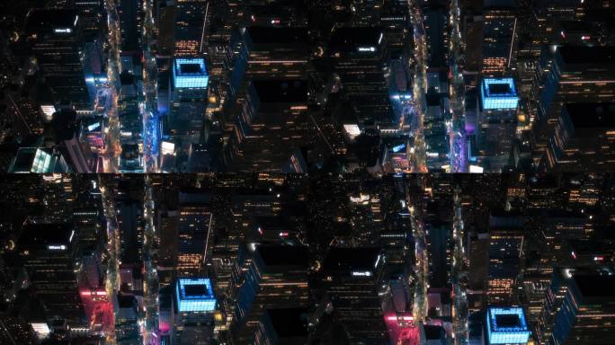 俯瞰纽约曼哈顿街道的夜景。直升机沿着一条笔直的无尽大道与汽车，出租车，公共汽车和其他交通工具飞行