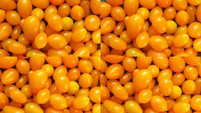 黄梨番茄背景。蔬菜市场，农业有机农场。新鲜湿润的泪滴状西红柿近距离旋转。营养，素食。健康饮食食材。旋