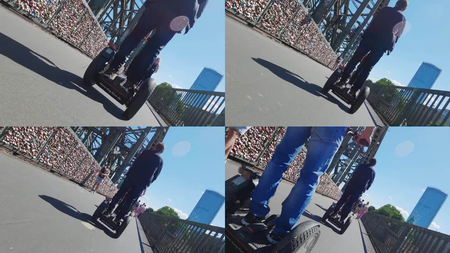 游客驾驶赛格威或悬浮滑板。德国科隆霍亨索伦桥上的自平衡电动滑板车，慢动作