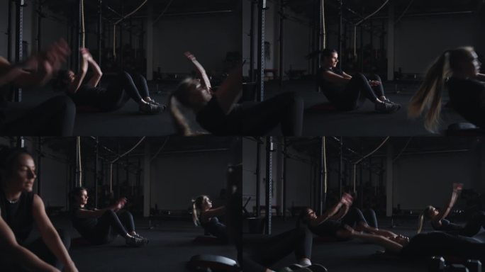 团体健身班，女性在健身房训练，在地板上做腹肌练习，健康锻炼
