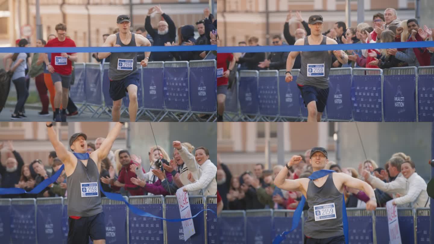 马拉松比赛中，男运动员在观众的欢呼声中冲过终点线的慢镜头。快乐成功的人庆祝胜利，实现他的目标，在比赛