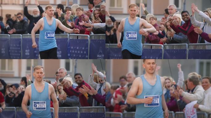 在马拉松比赛中，运动员男性慢跑者与他的支持者击掌，观众为他欢呼。热心友好的人参加比赛，专注于胜利