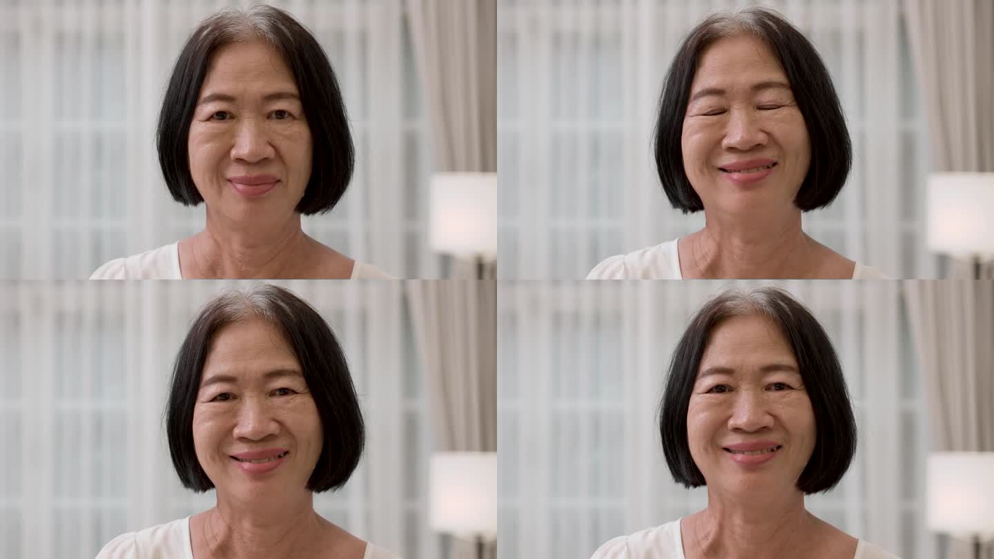 幸福的亚洲老年灰色头发的女性对着镜头微笑的特写