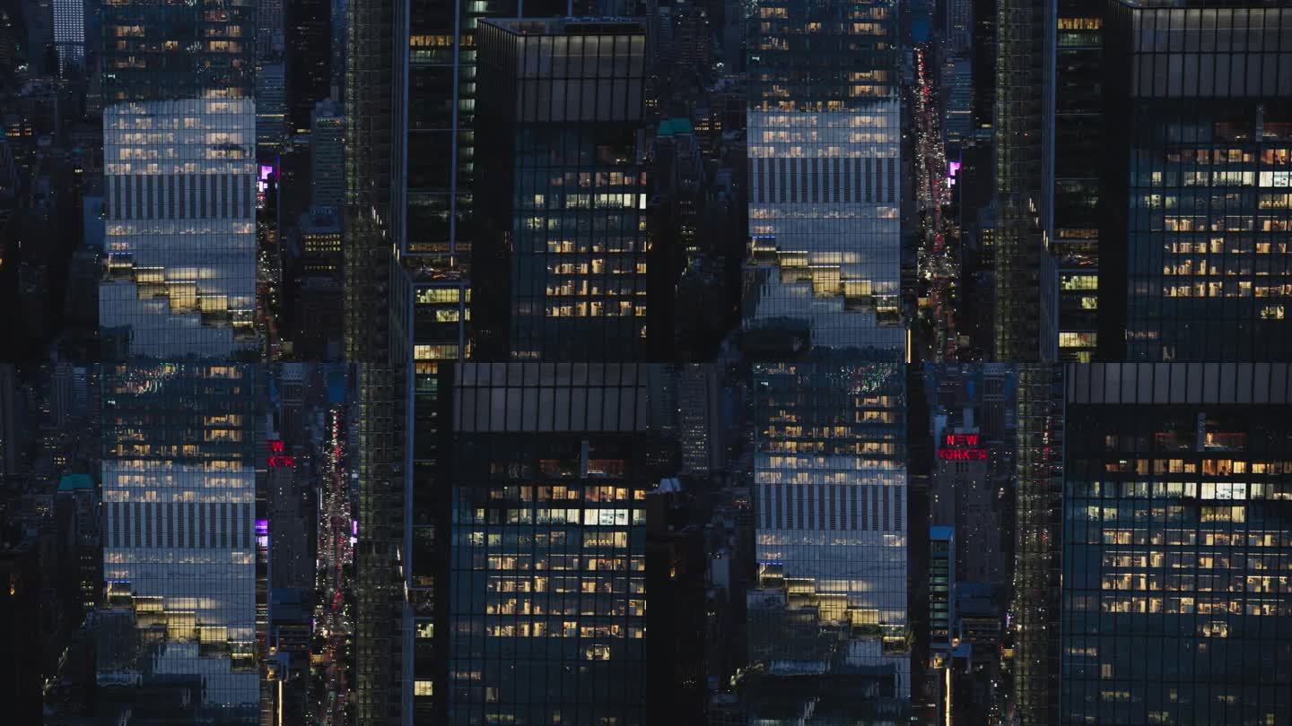 夜间办公大楼的近距离航拍镜头。在纽约，房间里亮着灯，商人和经理们长时间工作。直升机俯瞰曼哈顿的夜景