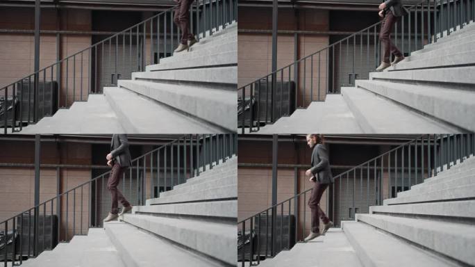男人急急忙忙地走上楼梯。商人走上台阶步行走出地铁的商人。抱负的概念与人爬楼梯。事业成功一步。