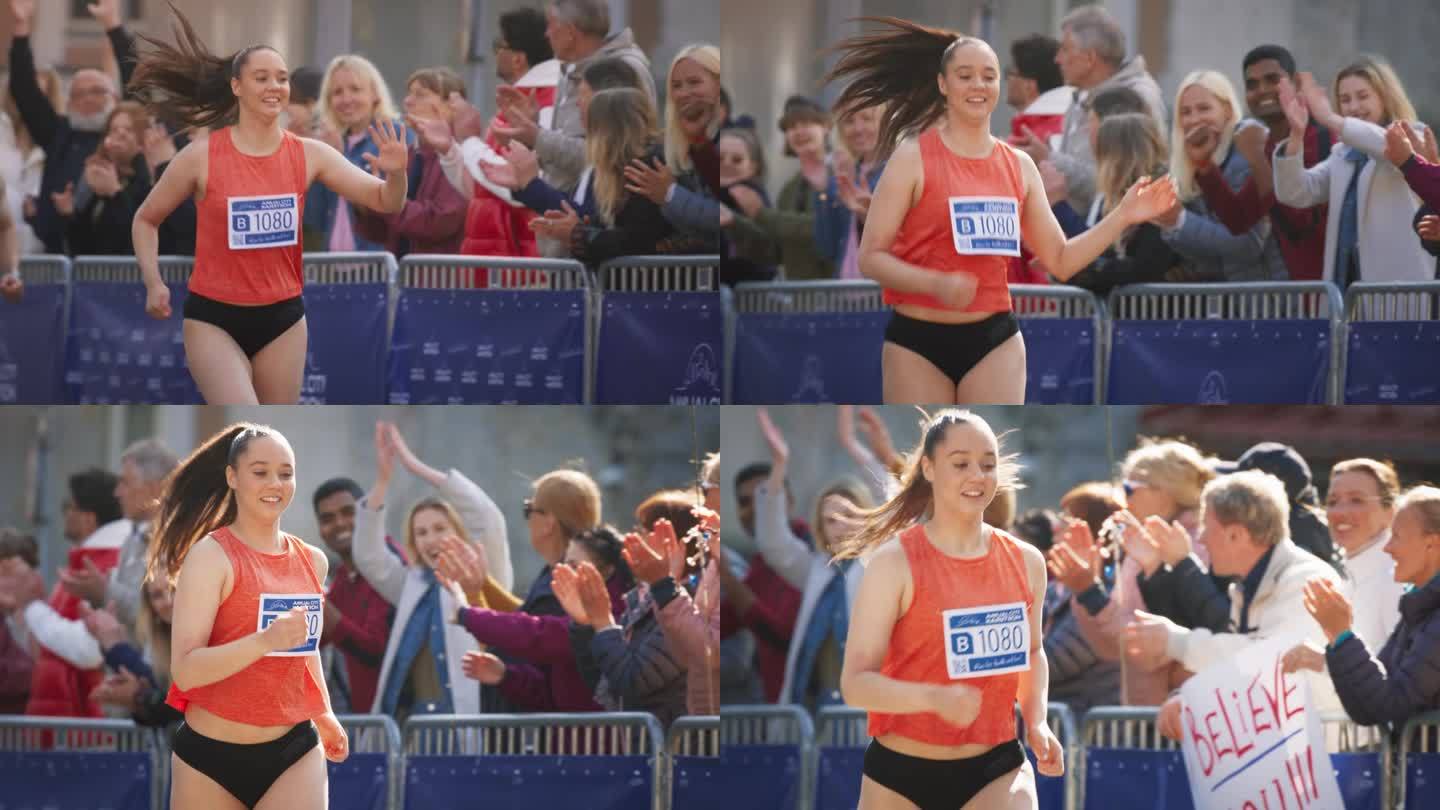 一个女人在公园里跑马拉松的慢动作肖像。强壮的女性慢跑者与其他跑步者争夺终点线的第一名