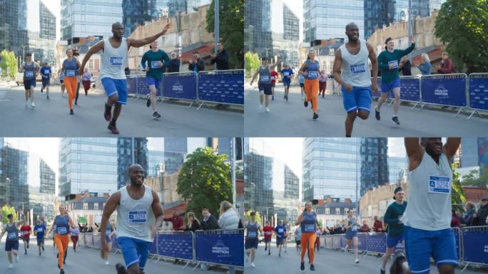 一个微笑的黑人青年在城市马拉松比赛中向支持他的观众挥手的慢动作肖像。友好快乐的男运动员庆祝在比赛中越