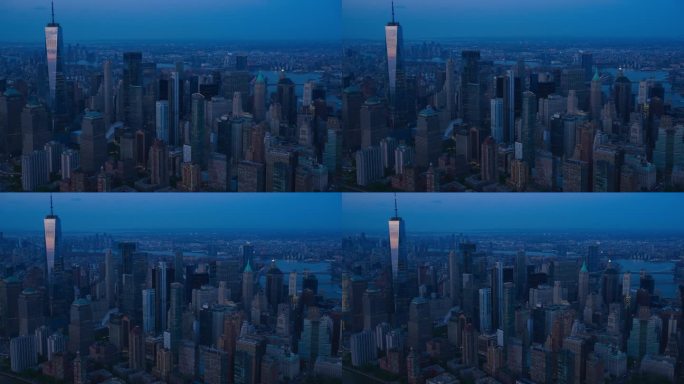 美国纽约市华尔街金融区的夜间全景飞行。在深蓝天空的夏夜，黑暗航拍的办公楼和摩天大楼