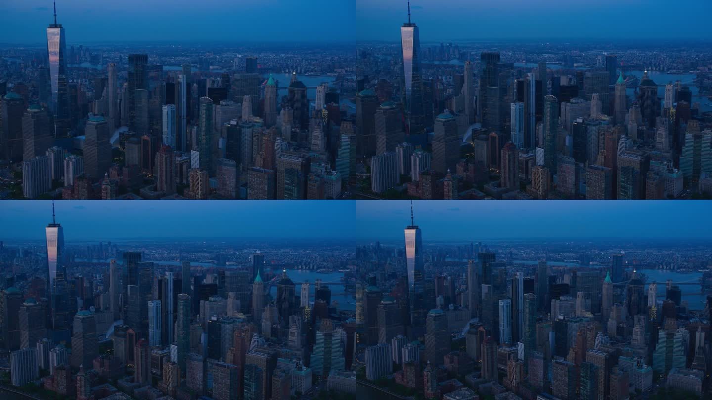 美国纽约市华尔街金融区的夜间全景飞行。在深蓝天空的夏夜，黑暗航拍的办公楼和摩天大楼
