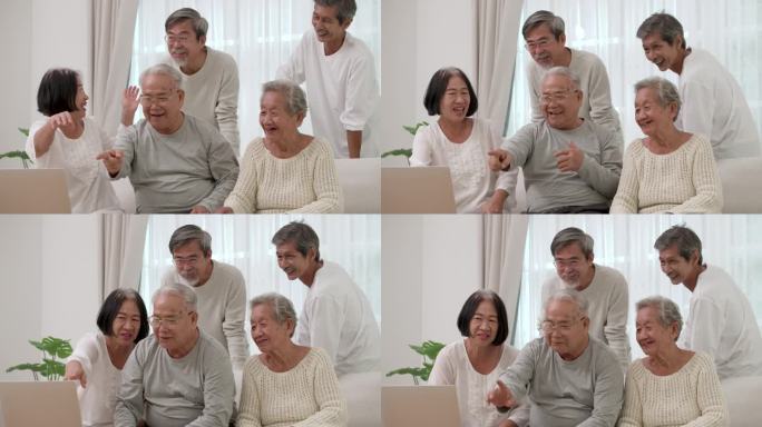 一群快乐的亚洲老人男女用笔记本电脑进行视频通话。