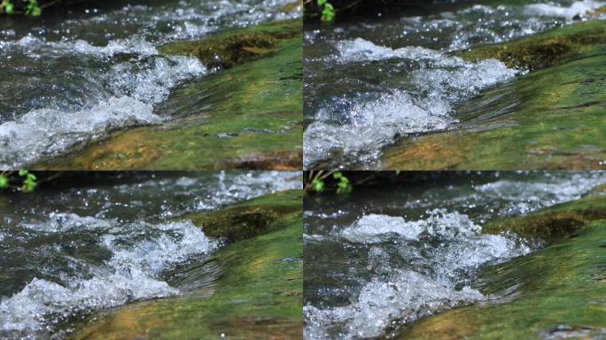 山间小溪溪水冲刷石头溅起水花