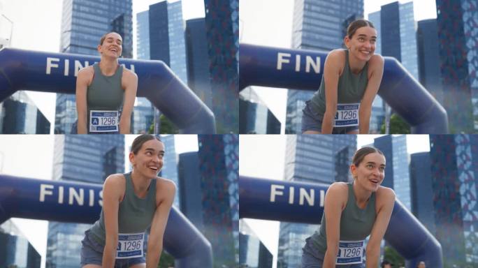 一位快乐的城市马拉松女选手穿过终点线，庆祝她的胜利。女冠军实现目标并享受她的成就