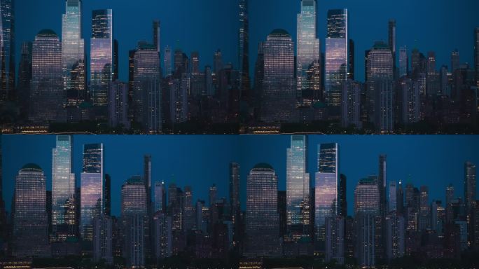 日落时纽约的直升机鸟瞰图。无人机镜头与曼哈顿下城历史摩天大楼反射傍晚的阳光。国际旅游和商业中心的城市
