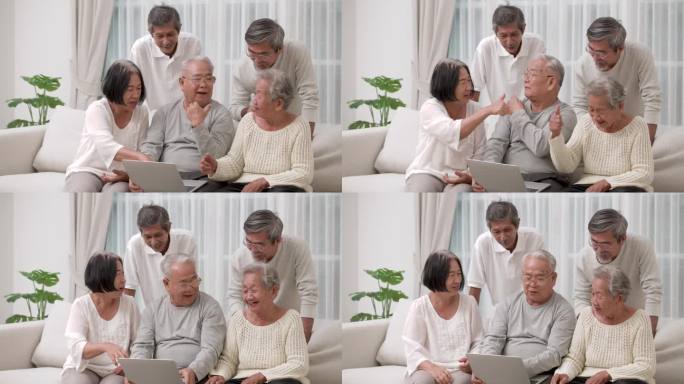 一群快乐的亚洲老人在讨论使用电脑的过程。