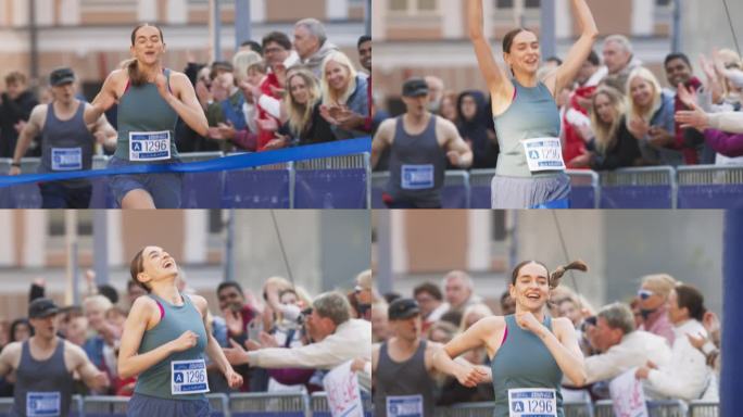 马拉松女运动员在观众的欢呼声中冲过终点线的慢镜头。快乐的成功女性庆祝胜利，为自己的成就感到鼓舞